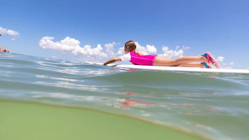 kid on surfboard in the water